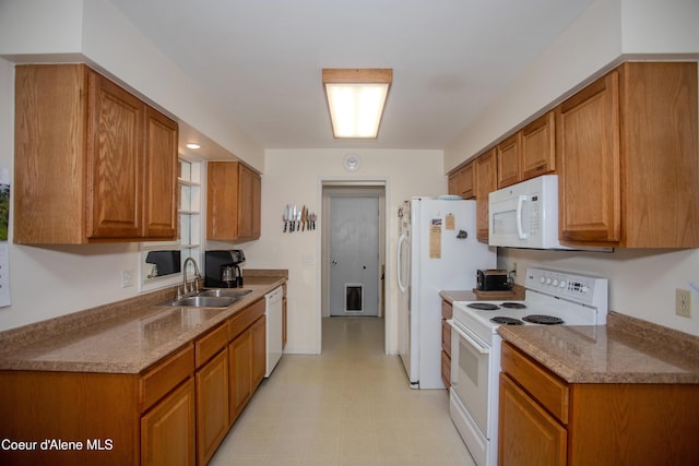 3420 E Poleline Ave, Post Falls, ID 83854 - kitchen featuring white appliances, a sink, light floors, and brown cabinetry