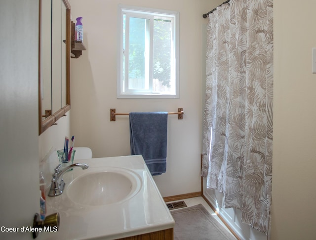 3420 E Poleline Ave, Post Falls, ID 83854 - bathroom featuring vanity, toilet, and a shower with curtain