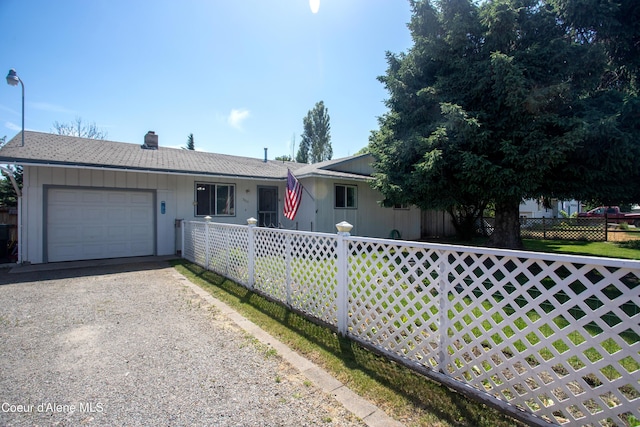 3420 E Poleline Ave, Post Falls, ID 83854 - ranch-style home with a garage, gravel driveway, and a chimney