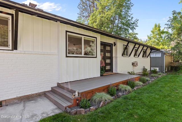 1113 N Lambert Ln, Coeur Dalene, ID 83814 - entrance to property featuring brick siding, a lawn, board and batten siding, and a deck