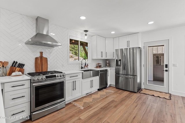 1113 N Lambert Ln, Coeur Dalene, ID 83814 - kitchen with stainless steel appliances, wall chimney range hood, light countertops, decorative backsplash, and white cabinetry