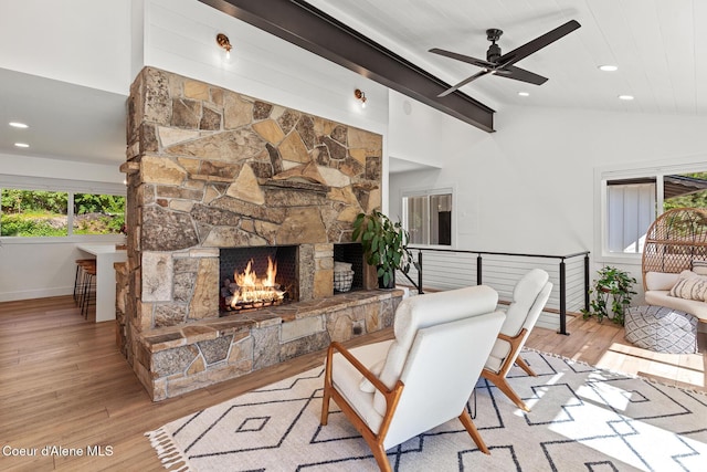 1113 N Lambert Ln, Coeur Dalene, ID 83814 - living area featuring vaulted ceiling, wood-type flooring, ceiling fan, a stone fireplace, and baseboards