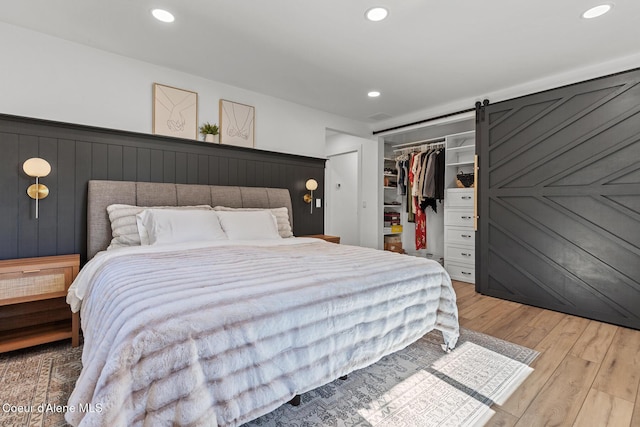 1113 N Lambert Ln, Coeur Dalene, ID 83814 - bedroom featuring wood finished floors, a barn door, recessed lighting, a closet, and a walk in closet