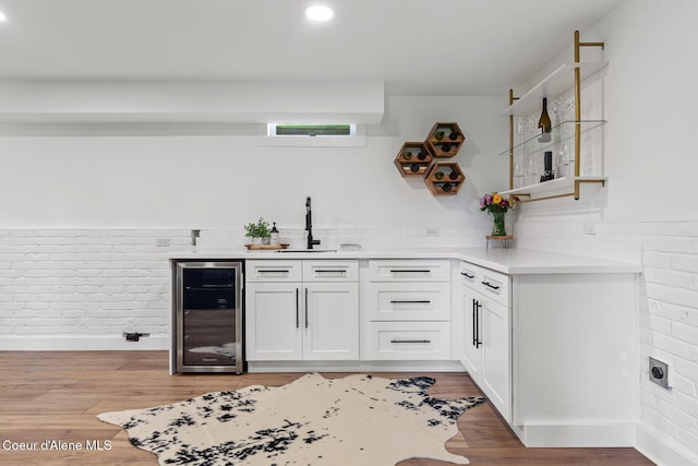 1113 N Lambert Ln, Coeur Dalene, ID 83814 - indoor wet bar with beverage cooler, brick wall, light wood-style flooring, and recessed lighting