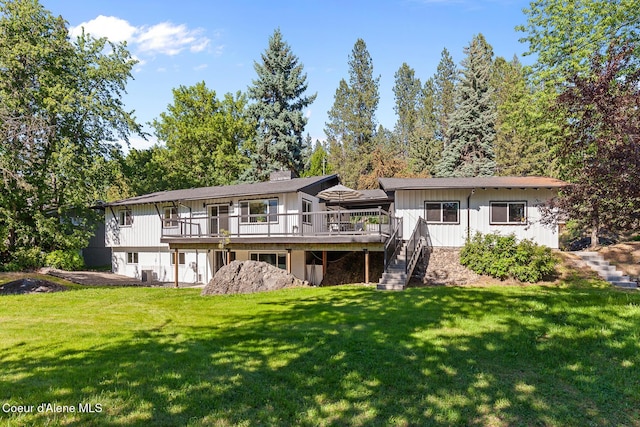 1113 N Lambert Ln, Coeur Dalene, ID 83814 - rear view of property featuring a wooden deck, stairs, a lawn, and board and batten siding