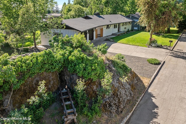 1113 N Lambert Ln, Coeur Dalene, ID 83814 - view of front of house featuring concrete driveway, a front lawn, a shingled roof, and a chimney