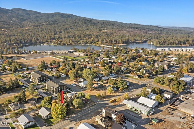 504 E 3rd Ave, Post Falls, ID 83854 - aerial view of property and surrounding area featuring a heavily wooded area and a water and mountain view