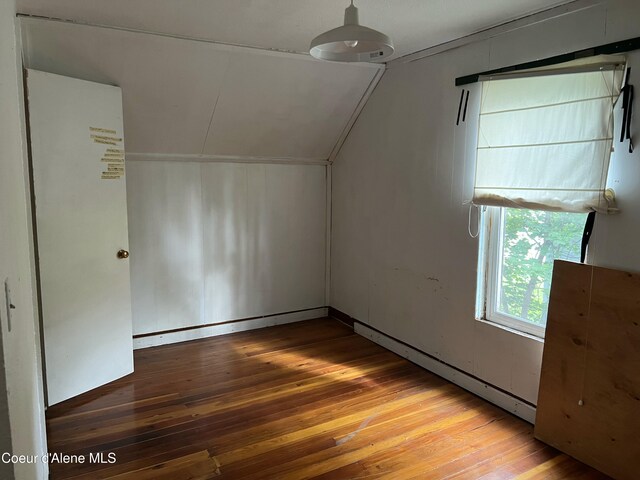 504 E 3rd Ave, Post Falls, ID 83854 - additional living space with hardwood / wood-style flooring, vaulted ceiling, and a baseboard radiator