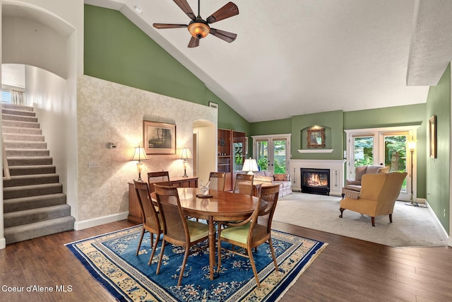 8511 N Summerfield Loop, Hayden, ID 83835 - dining room with high vaulted ceiling, stairs, baseboards, ceiling fan, and wood finished floors