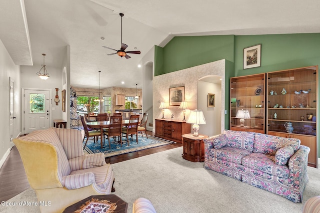 8511 N Summerfield Loop, Hayden, ID 83835 - living area featuring arched walkways, ceiling fan, high vaulted ceiling, wood finished floors, and baseboards