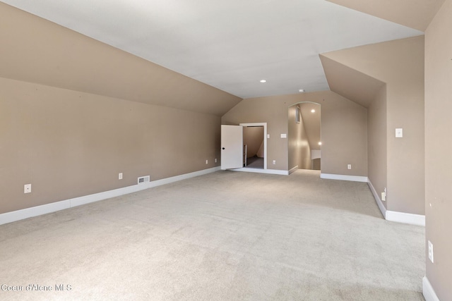 8511 N Summerfield Loop, Hayden, ID 83835 - additional living space with light colored carpet, vaulted ceiling, baseboards, and arched walkways