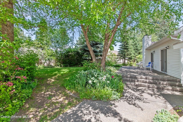 8511 N Summerfield Loop, Hayden, ID 83835 - view of green lawn featuring a deck