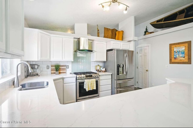 5820 E Steamboat Bnd, Post Falls, ID 83854 - kitchen featuring stainless steel appliances, wall chimney range hood, a sink, and tasteful backsplash