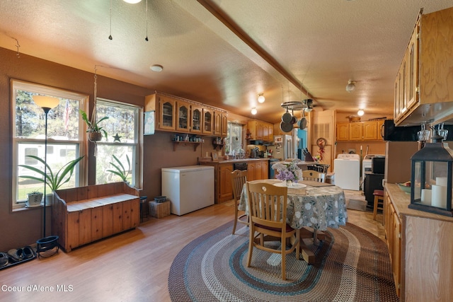 490 Samuels Rd, Sandpoint, ID 83864 - dining space featuring washer / dryer, a textured ceiling, and light wood finished floors