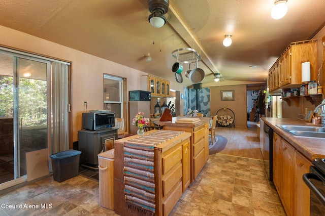 490 Samuels Rd, Sandpoint, ID 83864 - kitchen with a sink, vaulted ceiling, dishwashing machine, a ceiling fan, and stove