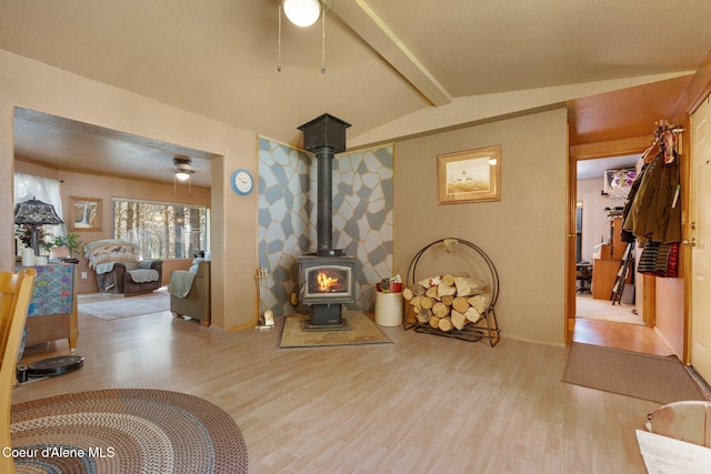 490 Samuels Rd, Sandpoint, ID 83864 - living room with a ceiling fan, wood finished floors, a wood stove, and baseboards