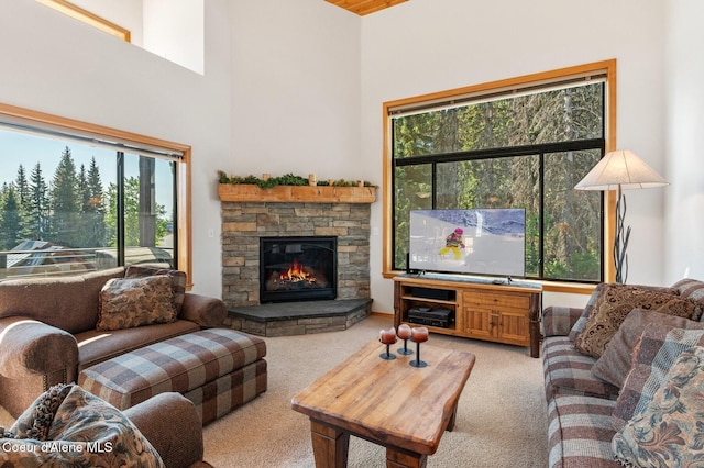 227 Crystal Springs Rd # 3, Sandpoint, ID 83864 - living room with light carpet, a stone fireplace, and a high ceiling