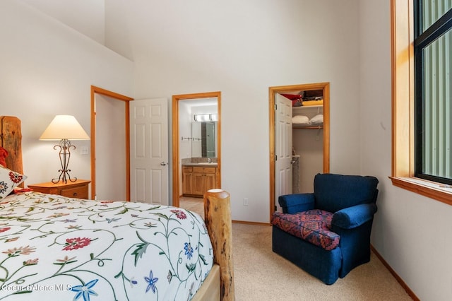 227 Crystal Springs Rd # 3, Sandpoint, ID 83864 - bedroom with light carpet, a walk in closet, a sink, a high ceiling, and a closet