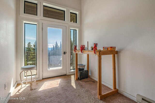 227 Crystal Springs Rd # 3, Sandpoint, ID 83864 - doorway to outside featuring carpet and a baseboard radiator