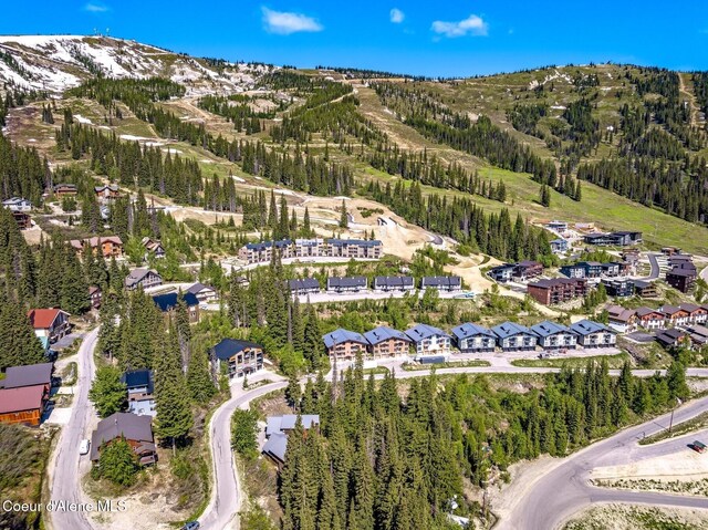 227 Crystal Springs Rd # 3, Sandpoint, ID 83864 - aerial view of property and surrounding area with a mountain backdrop and a heavily wooded area