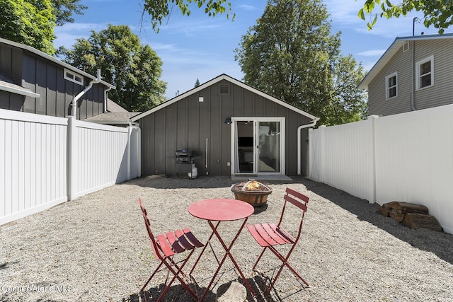 901 N 16th St, Coeur Dalene, ID 83814 - rear view of property featuring board and batten siding and a fire pit