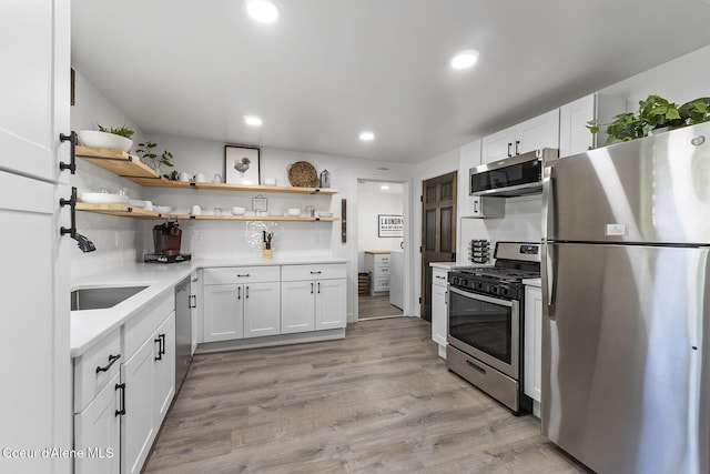 901 N 16th St, Coeur Dalene, ID 83814 - kitchen featuring stainless steel appliances, open shelves, decorative backsplash, light countertops, and recessed lighting
