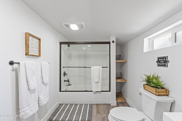 901 N 16th St, Coeur Dalene, ID 83814 - bathroom featuring toilet, wood finished floors, shower / bath combination with glass door, and baseboards