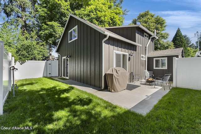 901 N 16th St, Coeur Dalene, ID 83814 - rear view of property with a gate, board and batten siding, a patio area, and an outdoor fire pit