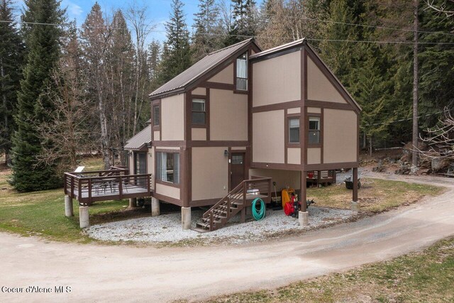 228 Snowgoose Ln Unit 8, Sandpoint, ID 83864 - view of side of home with metal roof and a wooden deck