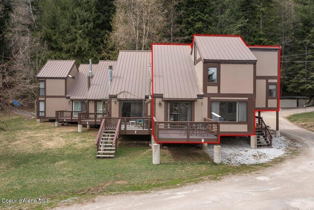 228 Snowgoose Ln Unit 8, Sandpoint, ID 83864 - view of front of house with stairway, metal roof, a wooden deck, and a front lawn