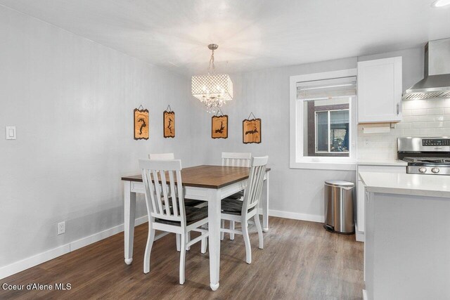 228 Snowgoose Ln Unit 8, Sandpoint, ID 83864 - dining space with wood finished floors, a chandelier, and baseboards