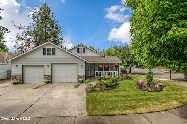 5835 E Steamboat Bnd, Post Falls, ID 83854 - view of front facade featuring covered porch, concrete driveway, a front lawn, a garage, and stone siding