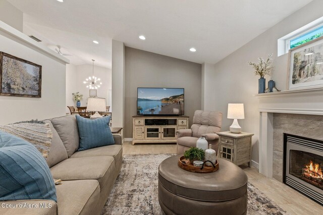 5835 E Steamboat Bnd, Post Falls, ID 83854 - living area with a premium fireplace, recessed lighting, light wood-type flooring, a chandelier, and vaulted ceiling