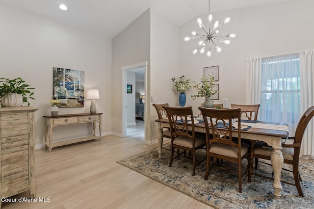 5835 E Steamboat Bnd, Post Falls, ID 83854 - dining area featuring high vaulted ceiling, a chandelier, light wood finished floors, and baseboards