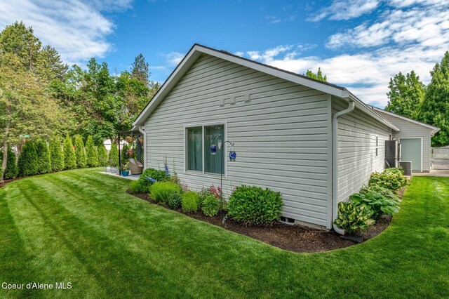 5835 E Steamboat Bnd, Post Falls, ID 83854 - view of side of home featuring a lawn and central air condition unit