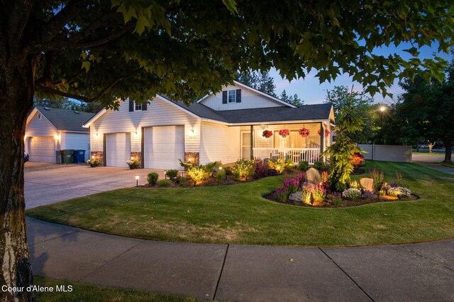 5835 E Steamboat Bnd, Post Falls, ID 83854 - view of front facade with driveway, a front yard, covered porch, and an attached garage