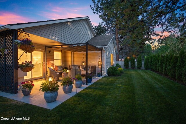 5835 E Steamboat Bnd, Post Falls, ID 83854 - back of property at dusk with a yard and a patio area