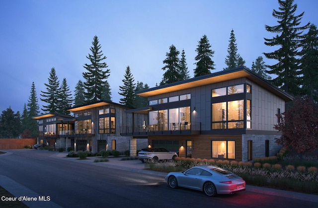 2193 W Bellerive Ln, Coeur Dalene, ID 83814 - contemporary home with a balcony and stone siding