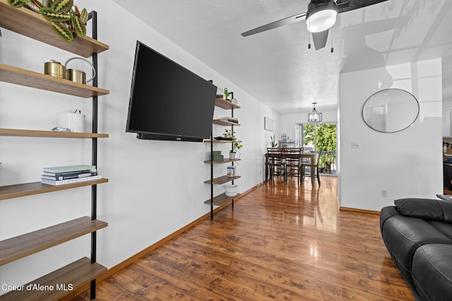 688 N Sparklewood Ct, Post Falls, ID 83854 - living room featuring ceiling fan, wood finished floors, and baseboards