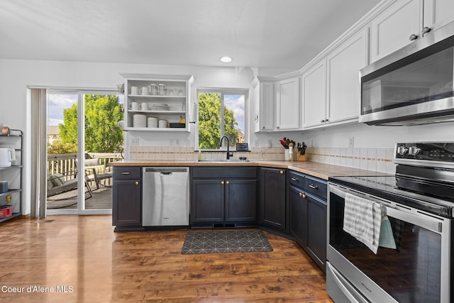 688 N Sparklewood Ct, Post Falls, ID 83854 - kitchen with appliances with stainless steel finishes, a sink, white cabinets, light countertops, and healthy amount of natural light