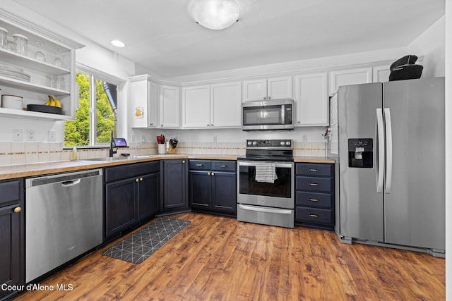 688 N Sparklewood Ct, Post Falls, ID 83854 - kitchen featuring stainless steel appliances, a sink, white cabinets, light countertops, and dark wood-style flooring