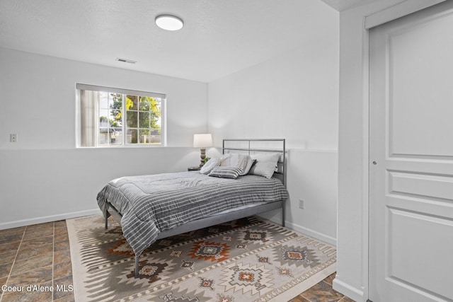688 N Sparklewood Ct, Post Falls, ID 83854 - bedroom with baseboards and stone finish flooring