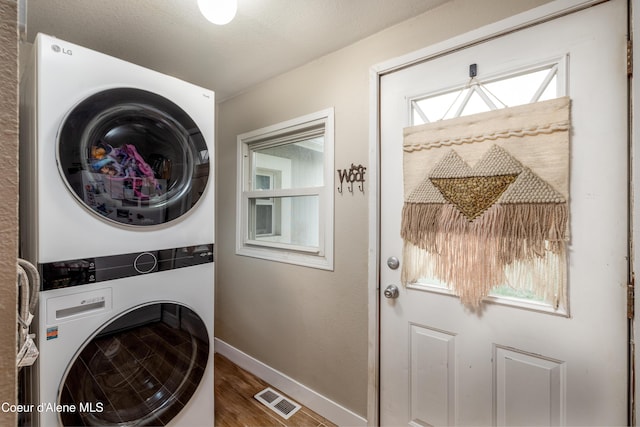1409 E Birch Ave, Coeur Dalene, ID 83814 - washroom with stacked washer / drying machine, baseboards, and wood finished floors