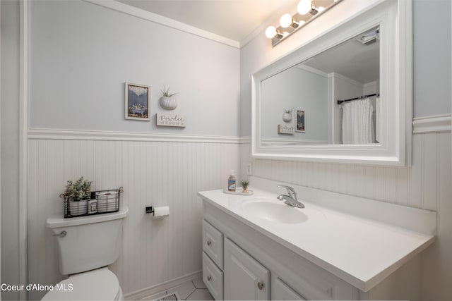 1409 E Birch Ave, Coeur Dalene, ID 83814 - bathroom featuring vanity, ornamental molding, toilet, and a wainscoted wall