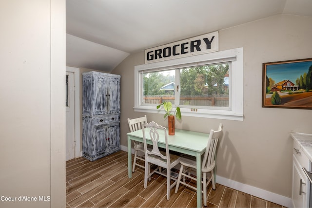 1409 E Birch Ave, Coeur Dalene, ID 83814 - dining area with lofted ceiling, wood finished floors, and baseboards