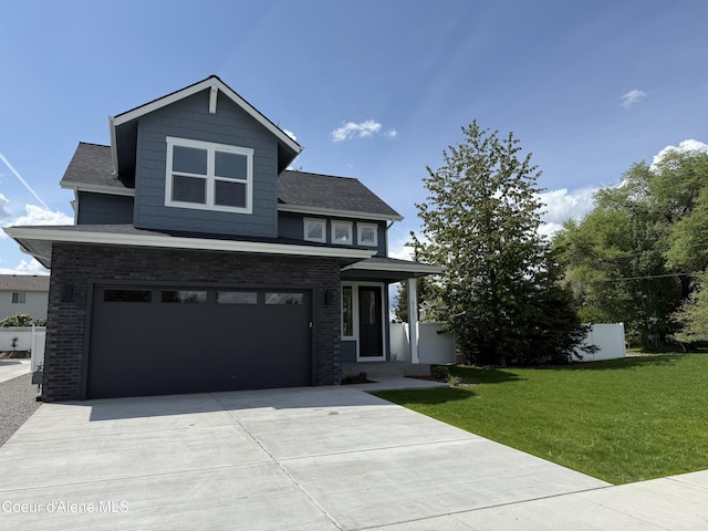 9151 N Raintree Ln, Hayden, ID 83835 - view of front of house featuring a front yard, an attached garage, driveway, and brick siding