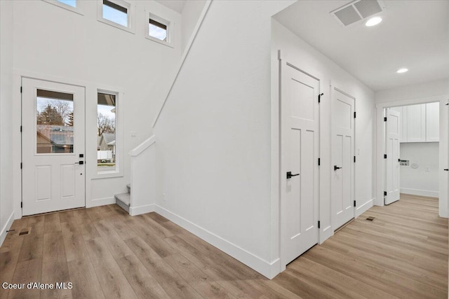 9151 N Raintree Ln, Hayden, ID 83835 - foyer entrance featuring light wood finished floors, baseboards, stairway, and recessed lighting