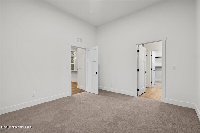 9151 N Raintree Ln, Hayden, ID 83835 - unfurnished bedroom featuring carpet flooring, baseboards, and a high ceiling