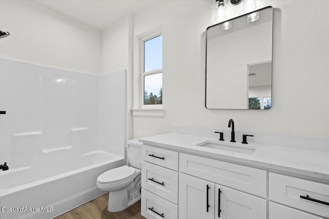 9151 N Raintree Ln, Hayden, ID 83835 - full bathroom featuring wood finished floors, vanity, toilet, and tub / shower combination
