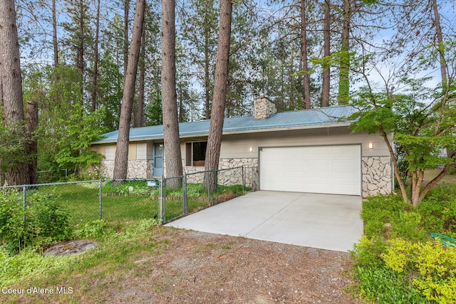 15248 N Atlas Rd, Rathdrum, ID 83858 - view of front of home with stone siding, driveway, and a chimney